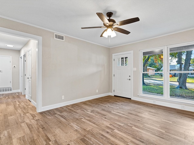 interior space featuring ornamental molding, light hardwood / wood-style flooring, and ceiling fan