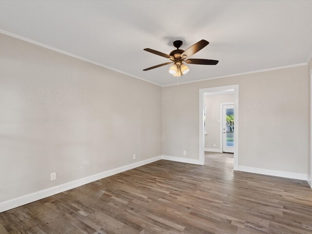 empty room featuring crown molding, hardwood / wood-style flooring, and ceiling fan