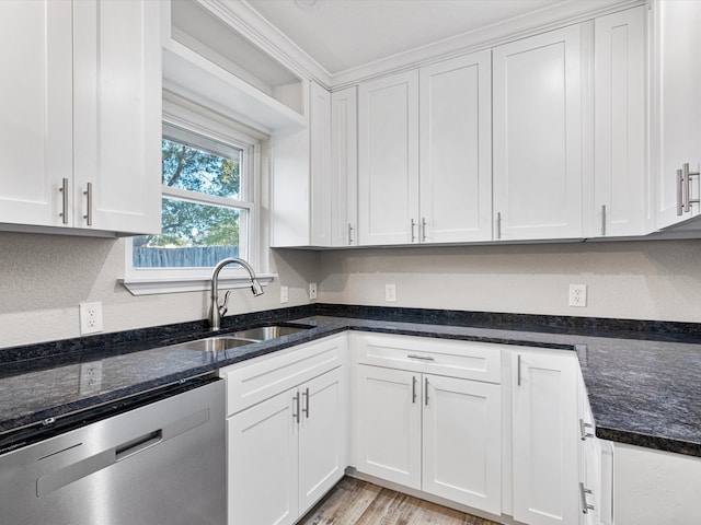 kitchen featuring dishwasher, sink, white cabinetry, light hardwood / wood-style floors, and dark stone counters