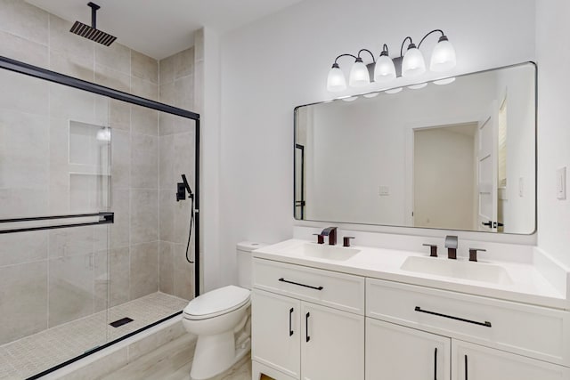 bathroom featuring vanity, hardwood / wood-style flooring, toilet, and an enclosed shower