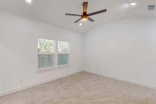 carpeted spare room with ceiling fan and lofted ceiling