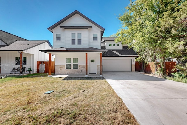 view of front of property featuring a front yard and a garage