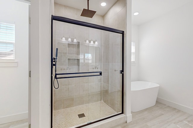 bathroom featuring separate shower and tub and hardwood / wood-style flooring