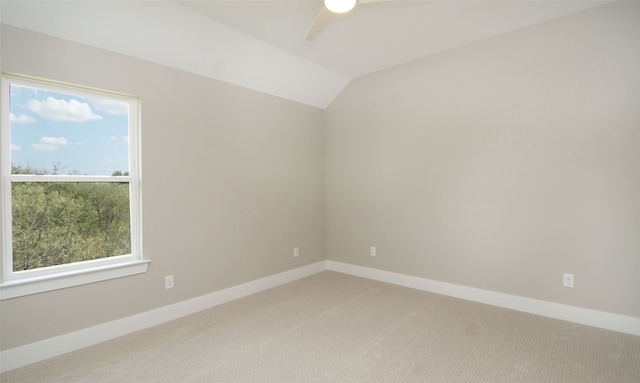 unfurnished room featuring lofted ceiling, carpet flooring, plenty of natural light, and ceiling fan