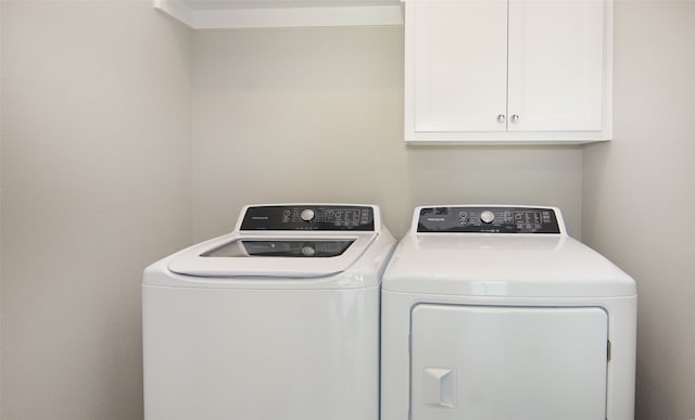 laundry area with cabinets and separate washer and dryer