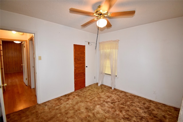 unfurnished bedroom with carpet floors and ceiling fan