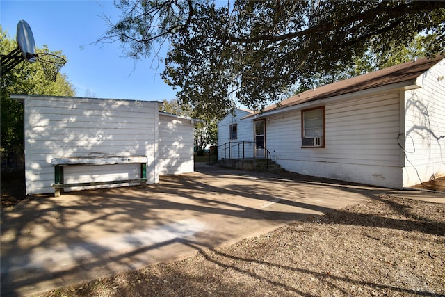 view of home's exterior featuring cooling unit and a patio area