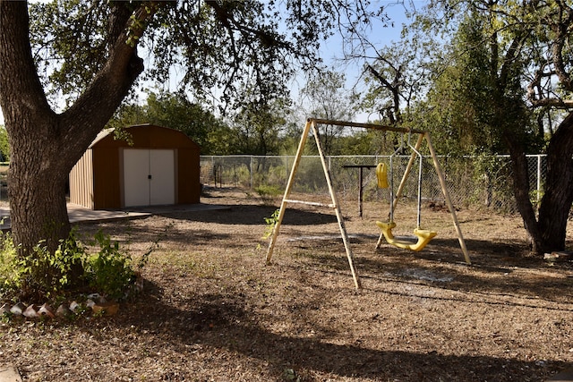 view of jungle gym featuring a storage shed