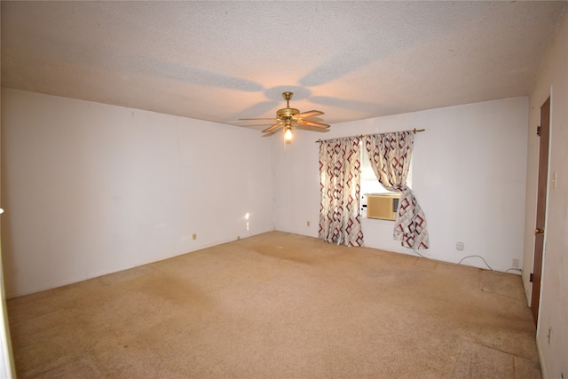 spare room with cooling unit, carpet floors, a textured ceiling, and ceiling fan