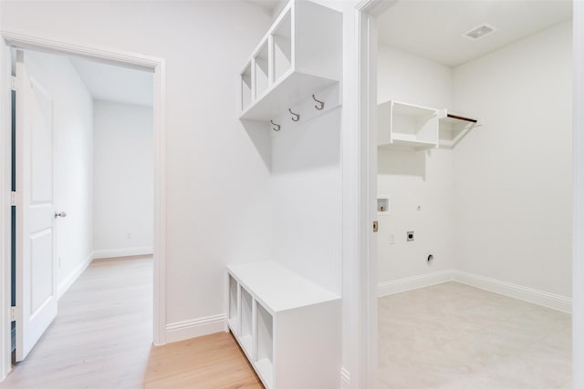 mudroom featuring light wood-style floors, baseboards, and visible vents