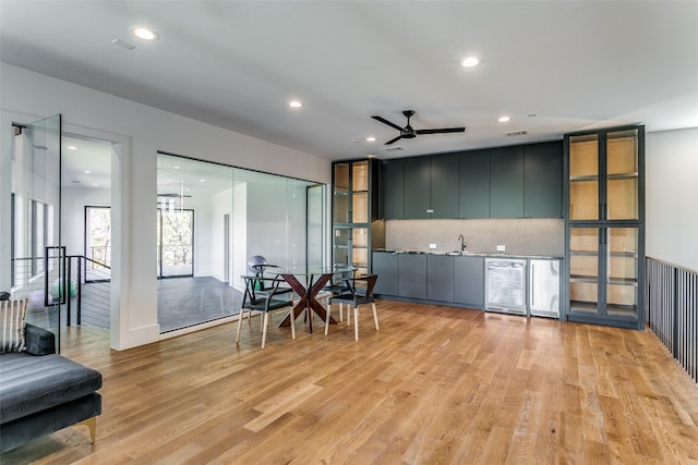 kitchen with light hardwood / wood-style flooring, wine cooler, tasteful backsplash, and ceiling fan