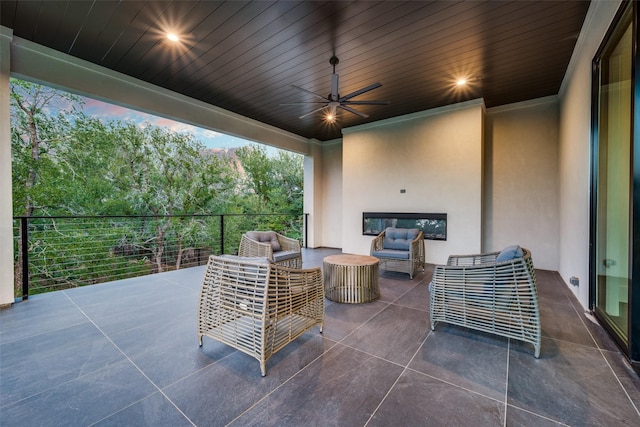 patio terrace at dusk with outdoor lounge area and ceiling fan