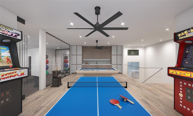 rec room with ceiling fan and light hardwood / wood-style flooring