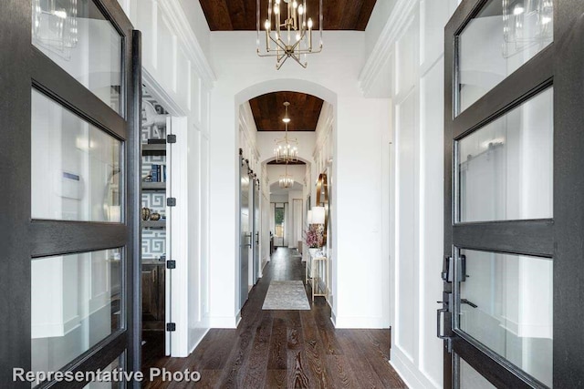 hall featuring dark hardwood / wood-style flooring and a high ceiling