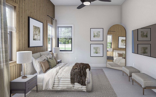 carpeted bedroom featuring ceiling fan and a towering ceiling