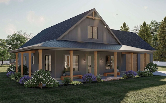 rear view of house with a porch and a lawn