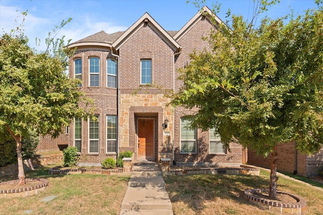 3615 Adriana Ave, Irving, TX 75038 - view of front facade featuring brick siding, a front lawn, and stone siding