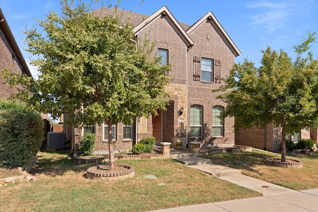 view of front of home featuring central air condition unit and a front lawn