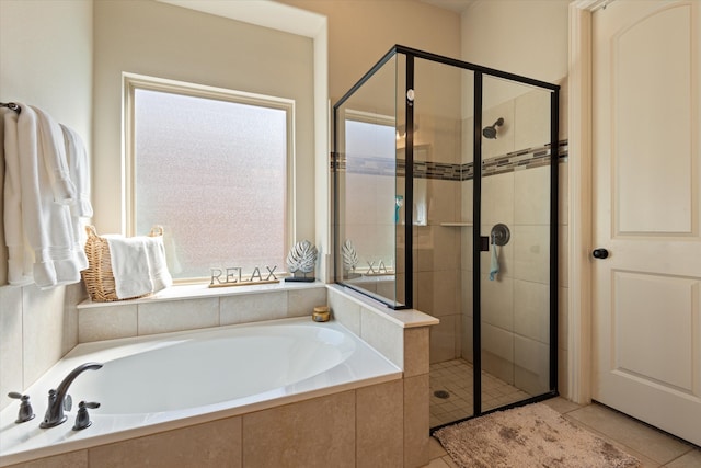 bathroom with independent shower and bath and tile patterned flooring