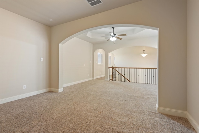 spare room featuring ceiling fan and carpet