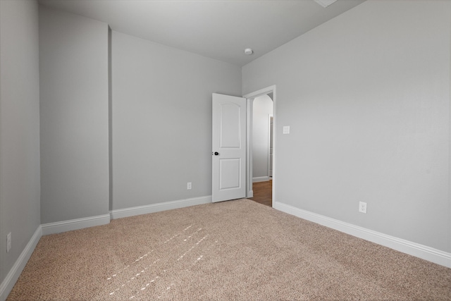 unfurnished room featuring carpet