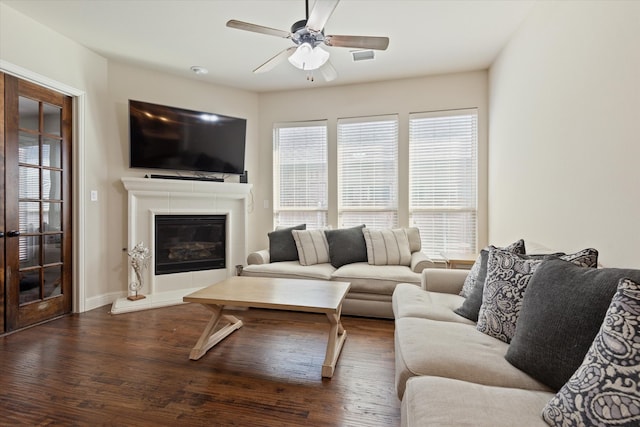 living room with ceiling fan and dark hardwood / wood-style flooring