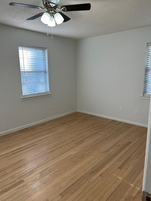 unfurnished room with ceiling fan, a textured ceiling, and light hardwood / wood-style flooring