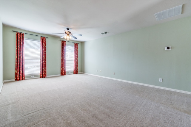 unfurnished room featuring light carpet and ceiling fan