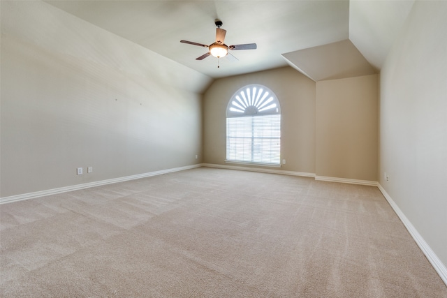 empty room with light carpet, lofted ceiling, and ceiling fan