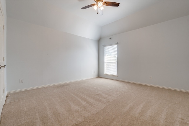 spare room featuring lofted ceiling, light colored carpet, and ceiling fan