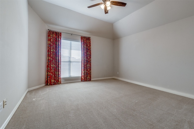 unfurnished room featuring light carpet, vaulted ceiling, and ceiling fan