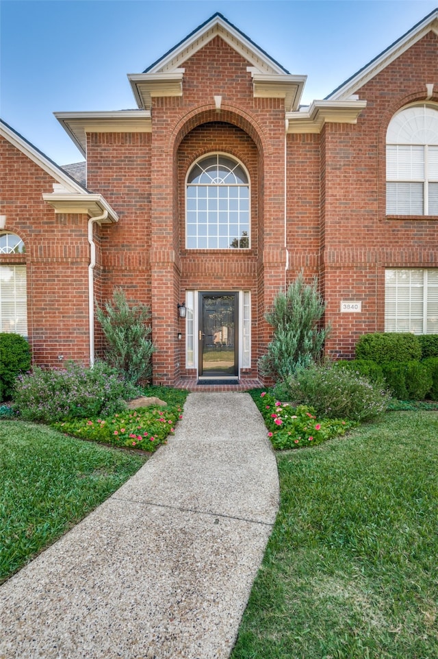 doorway to property featuring a lawn