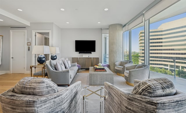 living room featuring light wood-style floors, baseboards, and recessed lighting