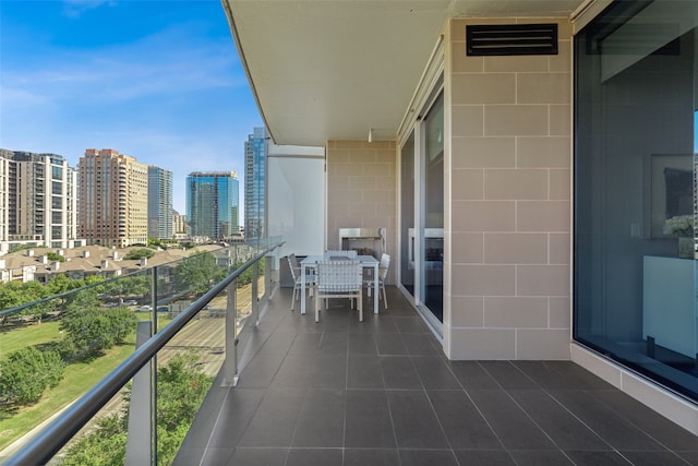 balcony with visible vents and a city view