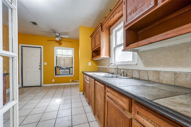 kitchen featuring sink, cooling unit, ceiling fan, and light tile patterned floors