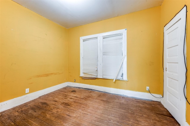 spare room with wood-type flooring