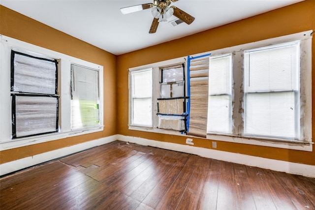 unfurnished room with ceiling fan and dark hardwood / wood-style floors