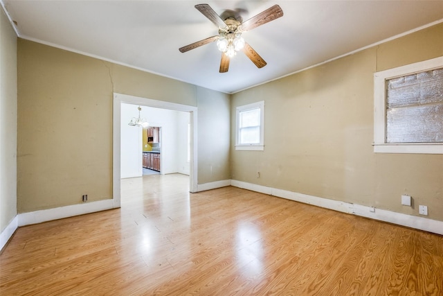 unfurnished room with light hardwood / wood-style floors, ornamental molding, and ceiling fan