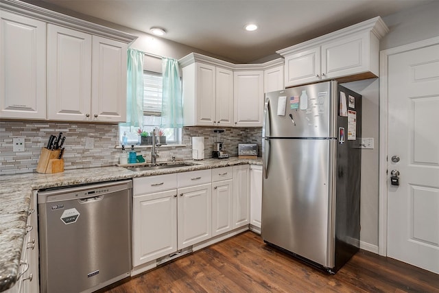 kitchen featuring white cabinetry, appliances with stainless steel finishes, and dark hardwood / wood-style floors