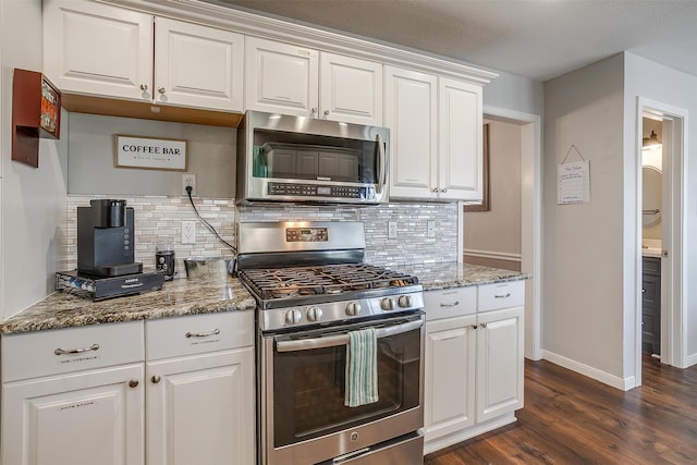 kitchen featuring stone countertops, appliances with stainless steel finishes, dark hardwood / wood-style floors, and white cabinetry