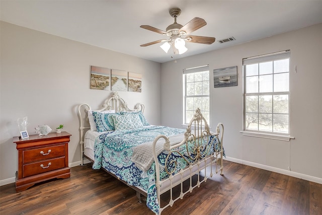 bedroom with dark hardwood / wood-style flooring and ceiling fan