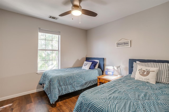 bedroom with dark wood-type flooring and ceiling fan