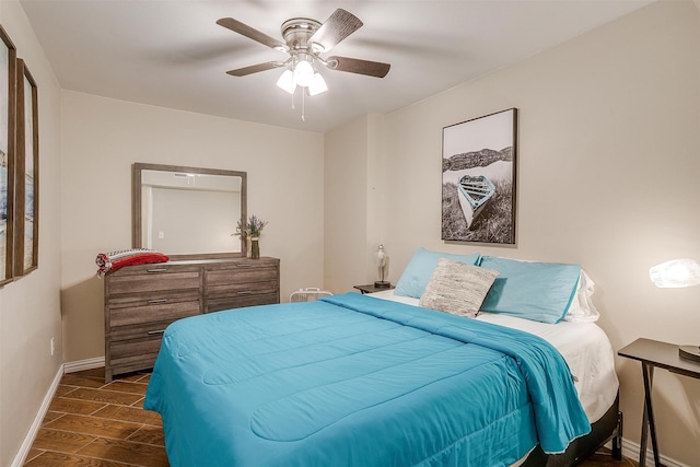 bedroom with dark hardwood / wood-style floors and ceiling fan