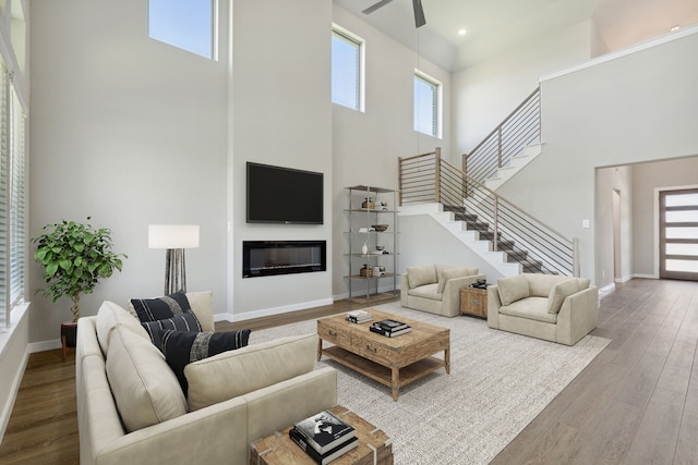 living room featuring hardwood / wood-style floors and a towering ceiling