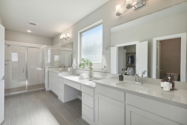 bathroom featuring vanity, tile patterned floors, toilet, and an enclosed shower