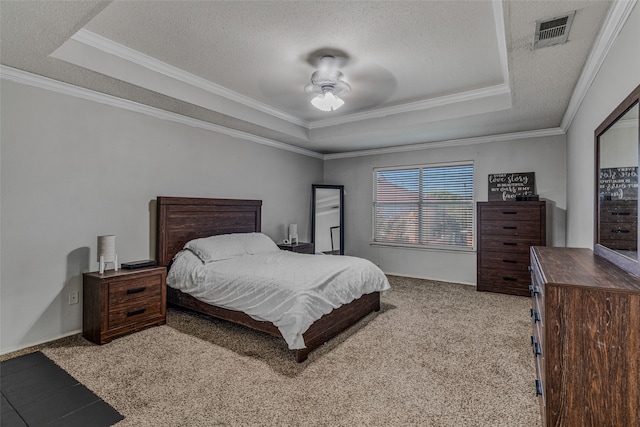 bedroom with ornamental molding, light carpet, ceiling fan, and a tray ceiling