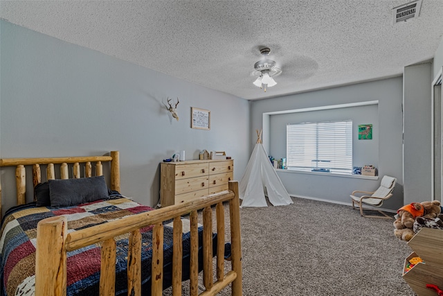 bedroom featuring a textured ceiling, carpet floors, and ceiling fan