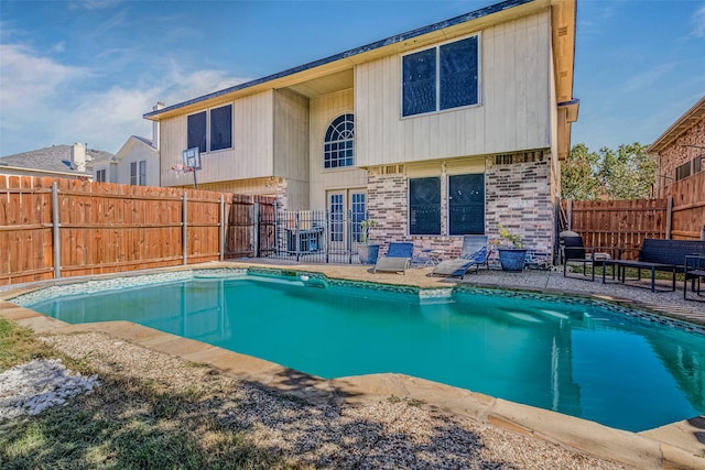 view of swimming pool featuring a patio area