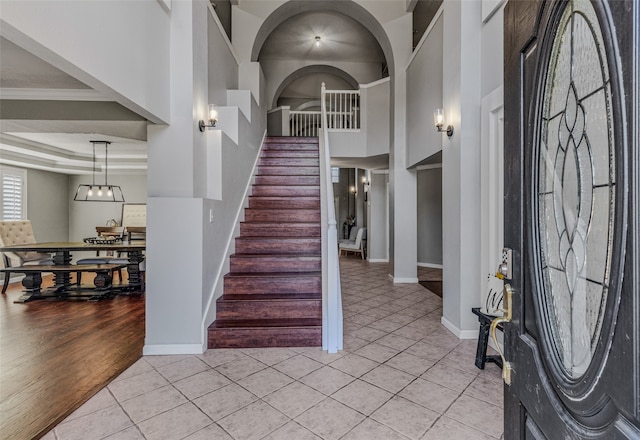 foyer entrance featuring light hardwood / wood-style floors and crown molding