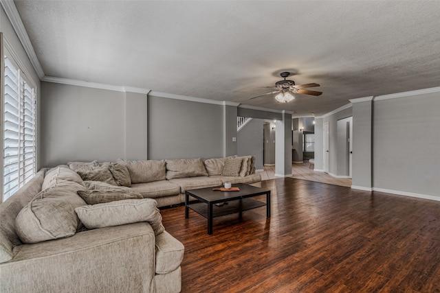 living room with dark wood-type flooring, a textured ceiling, and ceiling fan